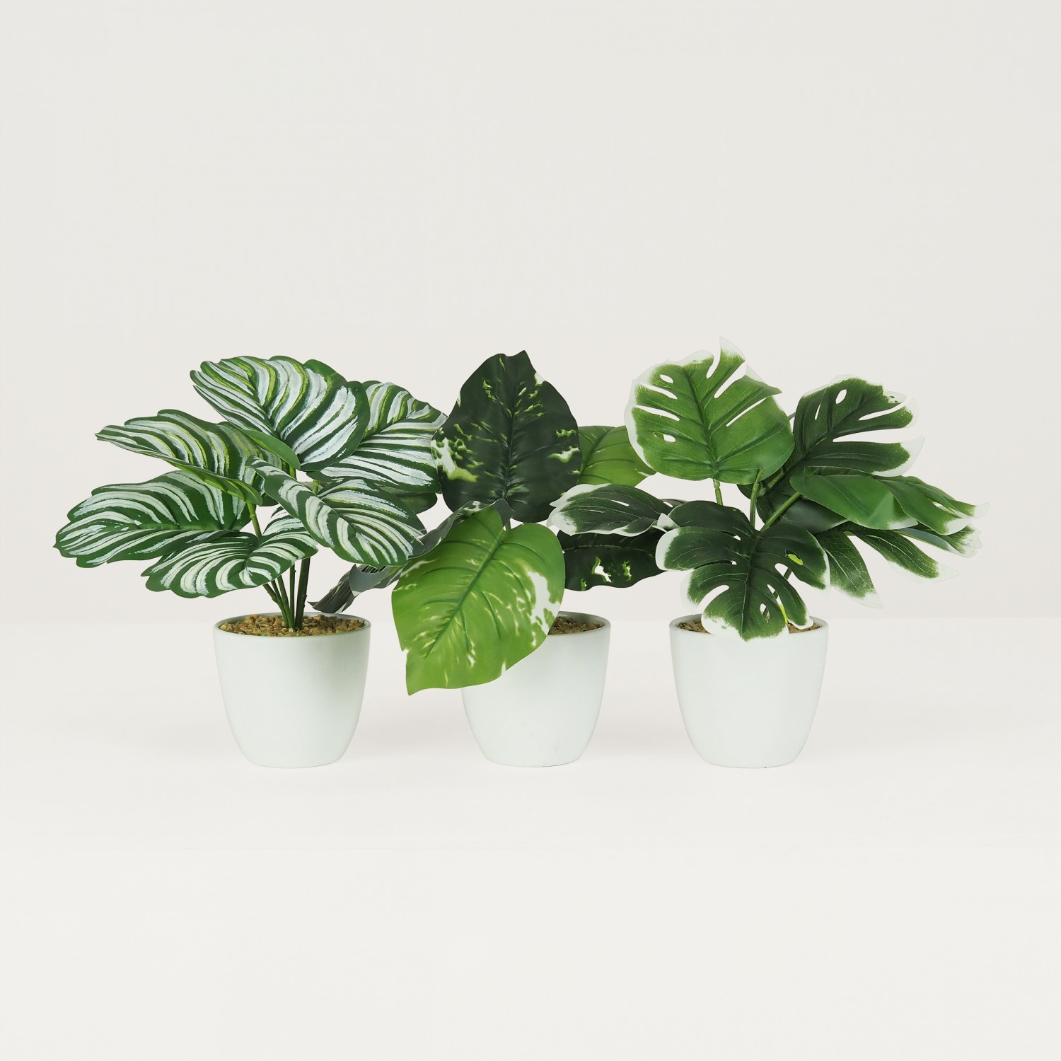 Plante verte artificielle 22cm lot de 3 sur fond beige