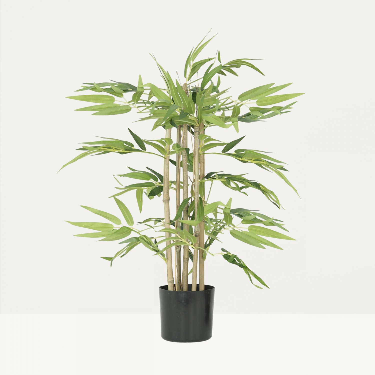 Bambou artificiel en pot 60cm sur fond beige