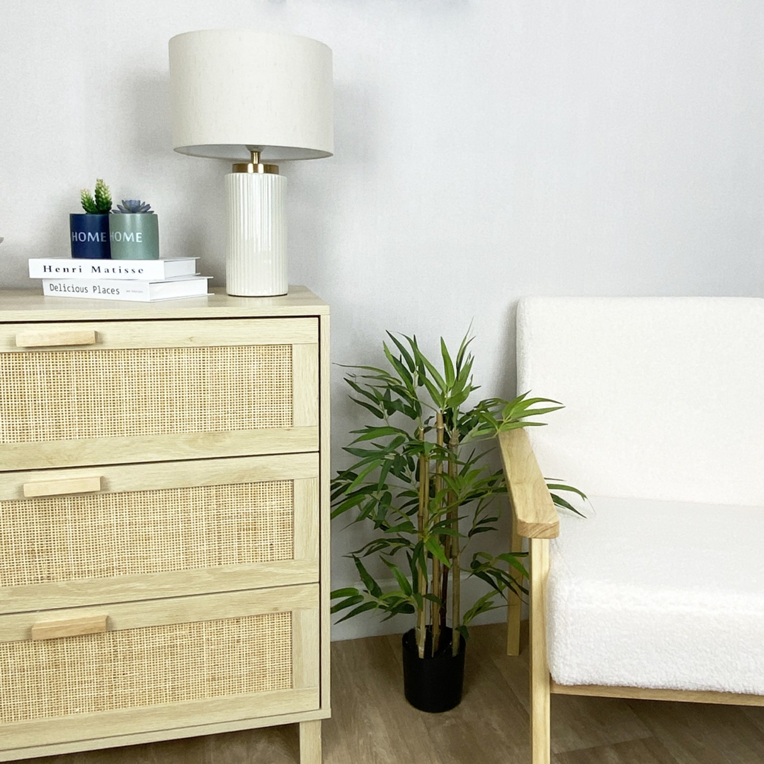 Bambou artificiel en pot 60cm posé au sol entre une commode et un fauteuil