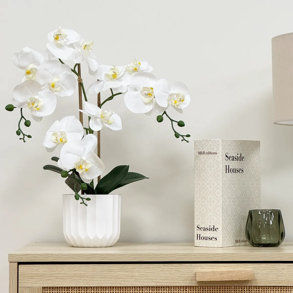 Orchidées artificielles toucher naturel blanc 52cm posée sur une commode focus